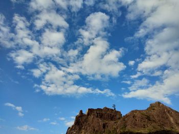 Low angle view of rock formations against sky