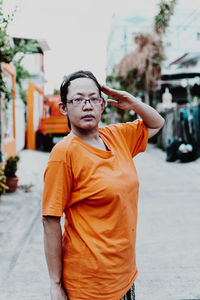 Portrait of woman standing on street in city