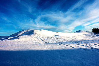 Scenic view of snowcapped mountain against blue sky