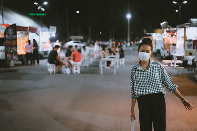 Series photo of young woman tourist wear surgical medical mask touring in street night market