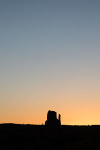 Silhouette landscape against clear sky during sunset