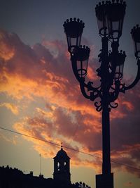 Low angle view of silhouette street light against sky