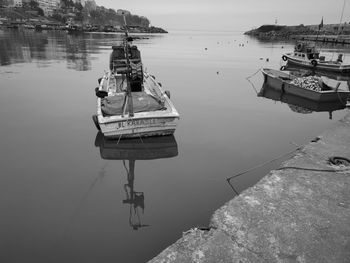 Sailboats moored on lake