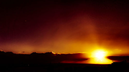 Scenic view of silhouette mountain against sky at sunset