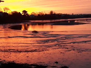 Scenic view of lake against sky during sunset