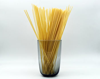 Close-up of bread in plate against white background