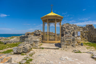 Old ruins of building against blue sky