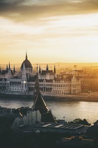 City at waterfront during sunset