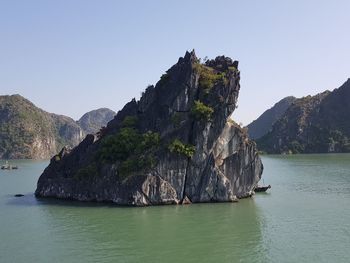 Panoramic view of rock on sea against clear sky