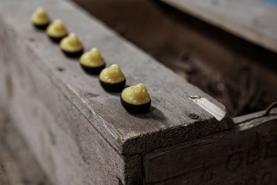 High angle view of chicken shape candies on wood during easter