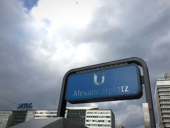 Low angle view of information sign against sky