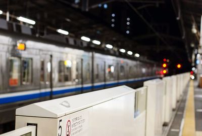 Train on railroad station platform at night