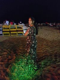 Portrait of woman standing at night