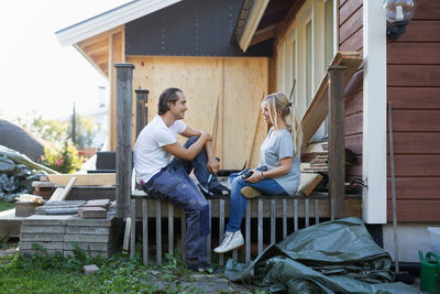 Happy couple looking at each other while renovating house