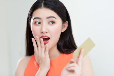 Portrait of a beautiful young woman over white background