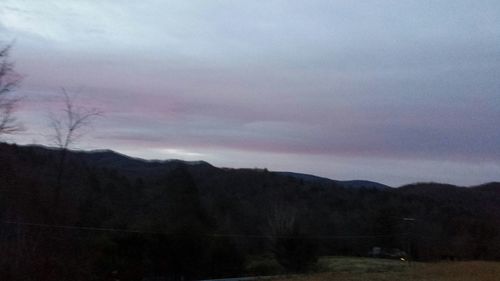 Scenic view of mountains against cloudy sky