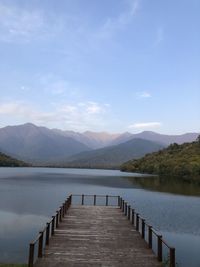 Pier over lake against sky