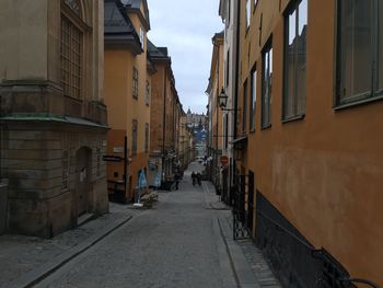 Footpath amidst buildings in city