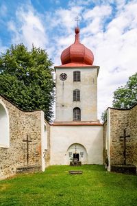 Church by building against sky