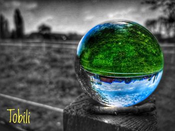 Close-up of crystal ball on glass