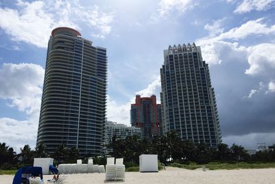 Modern buildings against cloudy sky