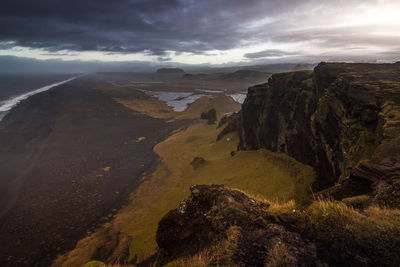 Scenic view of mountains against cloudy sky