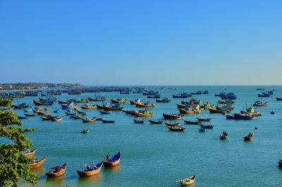 High angle view of sailboats in sea against clear sky