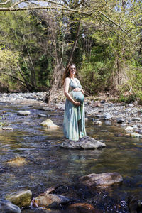 Woman standing on rock in forest