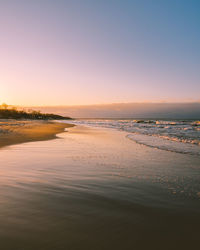 Scenic view of beach against sky during sunset