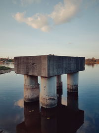 Built structure by sea against sky