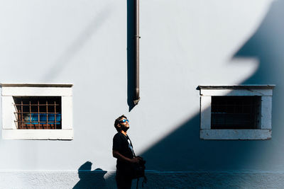 Full length of man standing against building