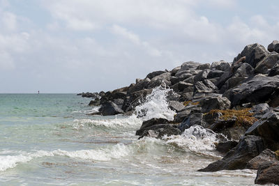 Scenic view of sea against cloudy sky