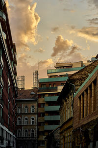 Buildings in city against sky during sunset