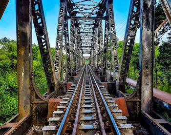 Railroad tracks amidst trees against sky