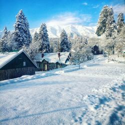 Snow covered landscape against sky