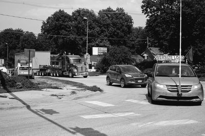 Cars on road against sky in city