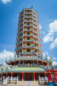 Chinese pagoda in the temple with cloudy blue sky, krabi, thailand