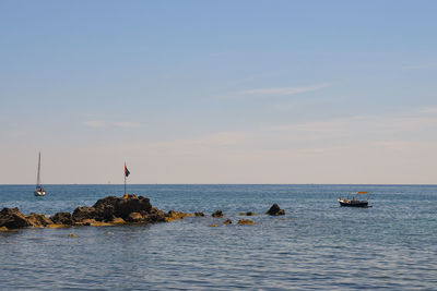 Seascape with boats and rocks, boccadasse, genoa, italy