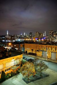 Illuminated cityscape against sky at night