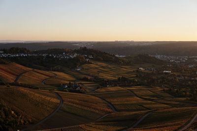 High angle view of agricultural field against sky during sunset