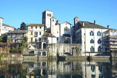 Buildings in city against blue sky