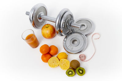 High angle view of fruits in plate on white background