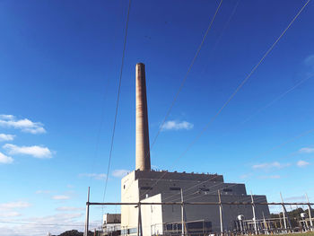 Low angle view of smoke stack against sky