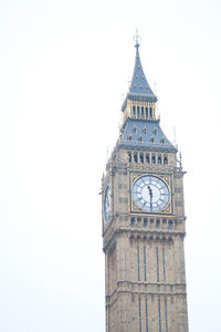 Low angle view of clock tower against clear sky