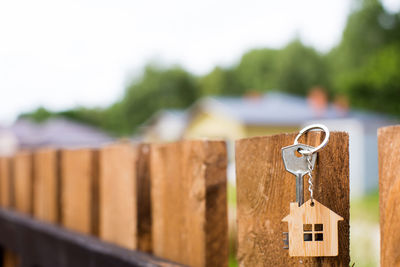 Close-up of padlock on fence against blurred background