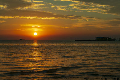 Scenic view of sea against orange sky