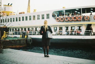 Woman standing by railing