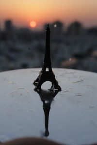 Close-up of water tower against sky during sunset