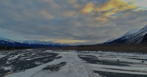 Scenic view of snowcapped mountains against sky during winter