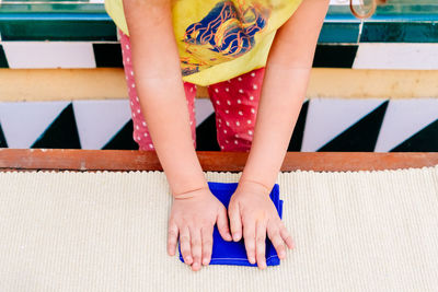 Midsection of girl folding napkin